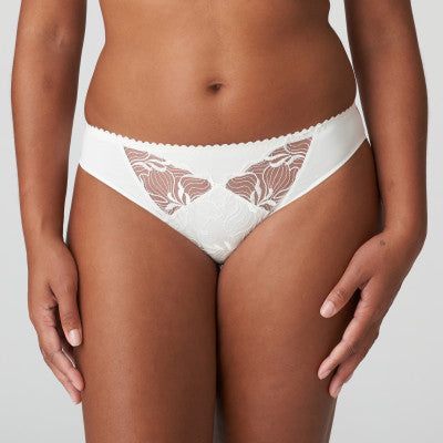 A sophisticated Rio brief in a beautiful opaque fabric. It has lovely sheer embroidery cutouts over the tummy. Ivory is a soft white shade that gently contrasts with the skin. Perfect under summer clothes or delightful as bridal lingerie. Fabric: Polyamide:70%, Elastane:15%, Cotton: 8%, Polyester:7%