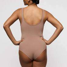 Load image into Gallery viewer, Person wearing a beige bodysuit against a plain background
