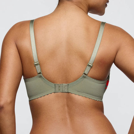 Green bra worn by a person on a plain background
