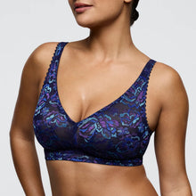 Load image into Gallery viewer, Blue floral lace bra on a model against a neutral background
