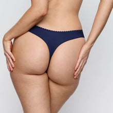 Load image into Gallery viewer, Navy blue bikini bottom worn by a person on a light gray background
