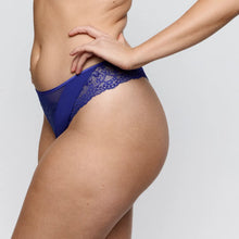 Load image into Gallery viewer, Person wearing a blue lace thong against a plain background
