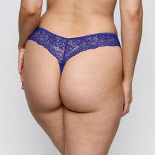 Load image into Gallery viewer, Person wearing a blue lace thong against a plain background
