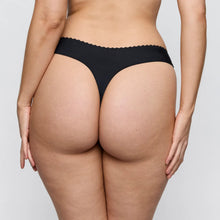 Load image into Gallery viewer, Rear view of a model wearing black high-cut underwear with a scalloped waistband against a light gray studio background.
