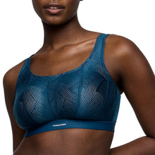 Load image into Gallery viewer, Blue sports bra with geometric pattern on a model against a white background
