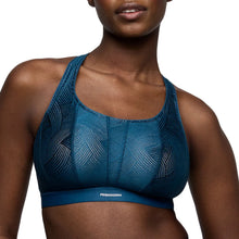 Load image into Gallery viewer, Blue sports bra with geometric pattern on a model against a white background
