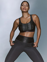 Load image into Gallery viewer, Woman wearing a black athletic outfit against a gray background
