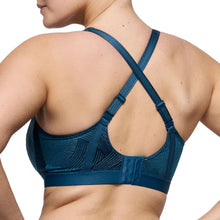 Load image into Gallery viewer, Blue sports bra with criss-cross straps on a white background
