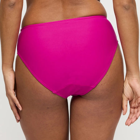 Person wearing bright pink high-waisted bikini bottoms on a plain background