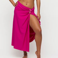 Person wearing a bright pink skirt with a buckle on a white background