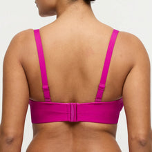 Load image into Gallery viewer, Person wearing a bright pink sports bra on a plain background
