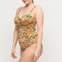 Load image into Gallery viewer, Woman wearing a colorful zigzag patterned swimsuit on a light gray background
