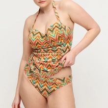 Load image into Gallery viewer, Woman wearing a colorful zigzag patterned swimsuit on a plain background
