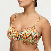 Load image into Gallery viewer, Woman wearing a colorful zigzag patterned bikini top on a light gray background
