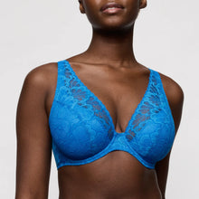 Load image into Gallery viewer, Blue lace bra worn by a model on a plain background
