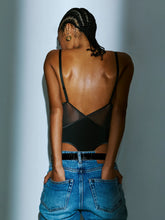 Load image into Gallery viewer, Person wearing a black mesh top and blue jeans against a light gray background
