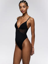 Load image into Gallery viewer, Model wearing a black swimsuit against a white background
