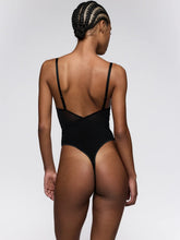 Load image into Gallery viewer, Person wearing a black swimsuit against a white background
