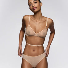 Load image into Gallery viewer, Woman wearing a beige bra and panties set on a plain background
