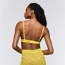 Load image into Gallery viewer, Woman wearing a yellow sports bra and shorts set on a plain background
