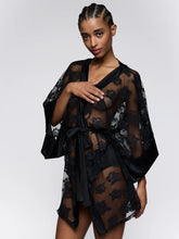 Load image into Gallery viewer, Woman wearing a black floral lace dress against a white background
