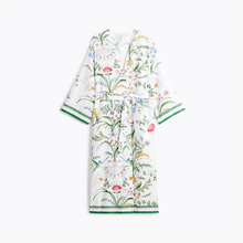 Load image into Gallery viewer, A long-sleeved wrap robe with a white base and an all-over botanical and bird print, featuring green striped cuffs and hem, shown flat against a white background.
