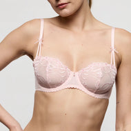 Pink lace bra worn by a model on a plain background