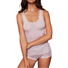 Load image into Gallery viewer, A woman modeling a rosewood pink pure silk ribbed camisole top and matching shorts set with calais lace trim, posed against a textured brown and gold background.
