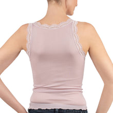 Load image into Gallery viewer, A woman wearing a rosewood pink ribbed pure silk camisole top with calais lace trim along the scoop neckline, posed against a pain white background.
