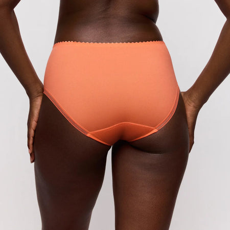 Person wearing orange underwear on a plain background