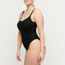 Load image into Gallery viewer, Black ribbed swimsuit worn by a model on a light gray background
