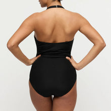 Load image into Gallery viewer, Person wearing a black ribbed swimsuit on a light gray background

