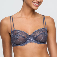 Load image into Gallery viewer, Woman wearing a blue lace bra against a neutral background
