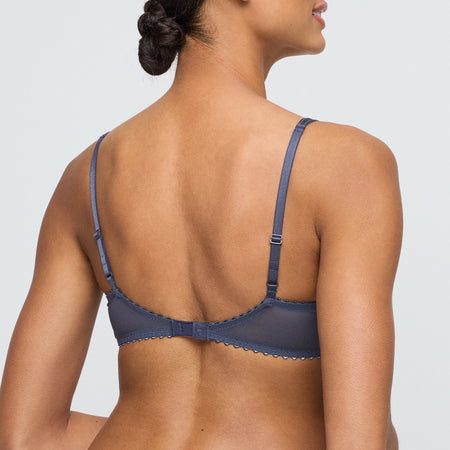 Navy blue bra worn by a model on a light gray background