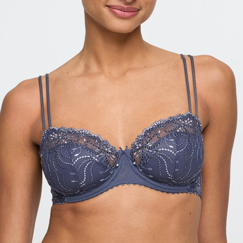 Navy blue lace bra on a model against a plain background