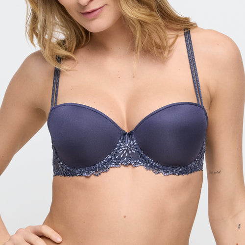 Navy blue bra with lace trim worn by a model on a white background
