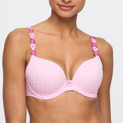 Pink bra with floral straps worn by a model on a white background