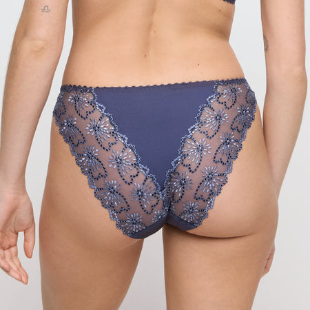 Navy blue lace underwear on a plain background