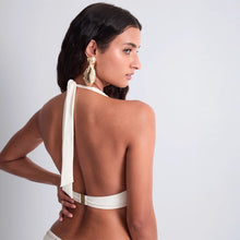 Load image into Gallery viewer, This stunning Simmer Stars formed plunge bikini top by Aubade showcases an elegant cream design enhanced by a double row of gleaming golden studs. The halter neck is a timeless classic that offers a flattering shape.

The lightly moulded cup on the top is underwired for additional support and light padding ensures a comfortable fuller fit.

This is a refined choice for those seeking both style and empowerment in their swimwear collection.
