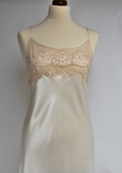 Beautiful full length pure silk satin nightgown. The bodice is composed of sheer contrasting ecru embroidered lace. Full length in a heavy silk satin, there is a slit to the side for ease when sleeping. The scooped to waist back with lace trim is stunning. The nightdress is cut on the bias for full movement. The rouleau straps give an extra finesse to this delightful nightgown.