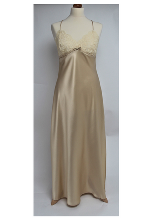 Full length pure silk satin nightgown. The bust line is composed of sheer honey lace. Full length in a heavy silk satin, there is a slit to the side for ease when sleeping. The nightdress is cut on the bias for full movement. The rouleau straps give an extra finesse to this delightful nightgown. 