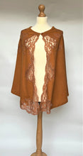 Load image into Gallery viewer, SALE Marjolaine Poncho style Bedjacket in a warm copper shade. Made from 100% pure cashmere it has colour matched appliqué lace inserts at the front, running along the opening edge, finishing beautifully on the corners of the hem edge. There is a one cashmere covered button detail.  Fabric: 100% Cashmere Lace: Leavers-Calais 

