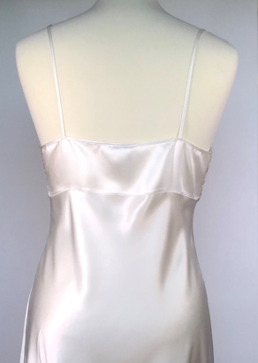 Full length pure Silk nightgown. It has a delicate embroided bodice (lined at the back for full coverage) in a ecru lace. Full length in a heavy silk satin, there is a slit to the side for ease when sleeping. 