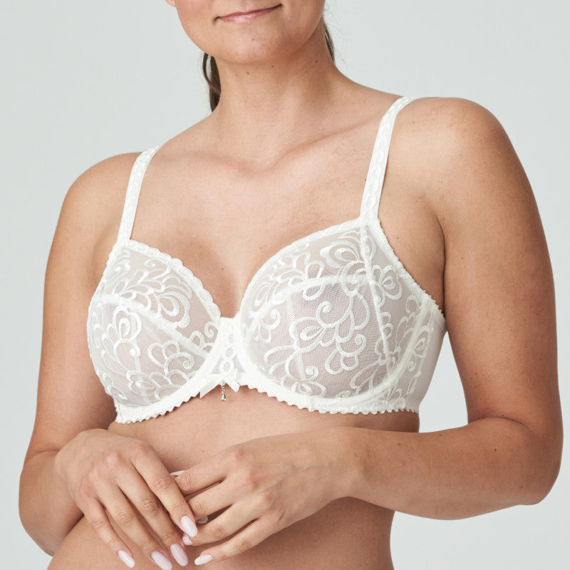 This underwire bra is feminine, comfortable, and super-luxurious. The bra provides full coverage with tulle and all-over embroidery embellishments. Small rhinestones on the bridge provides the finishing touch. The feminine, ivory colour is perfect under light-coloured summer outfits. Pure elegance! The bra has 3 panels providing full support.  Fabric content: Polyamide: 61%, Polyester: 26%, Elastane: 13%